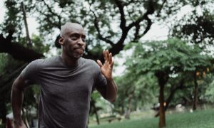 A man thinks about the stock losses in his TFSA as he jogs through a leafy park