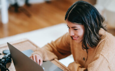 A woman reading the MoneySense list of "Best online brokers in Canada for 2023" on her laptop.