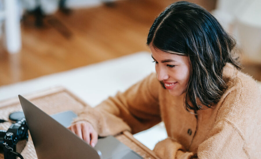 A woman reading the MoneySense list of "Best online brokers in Canada for 2023" on her laptop.