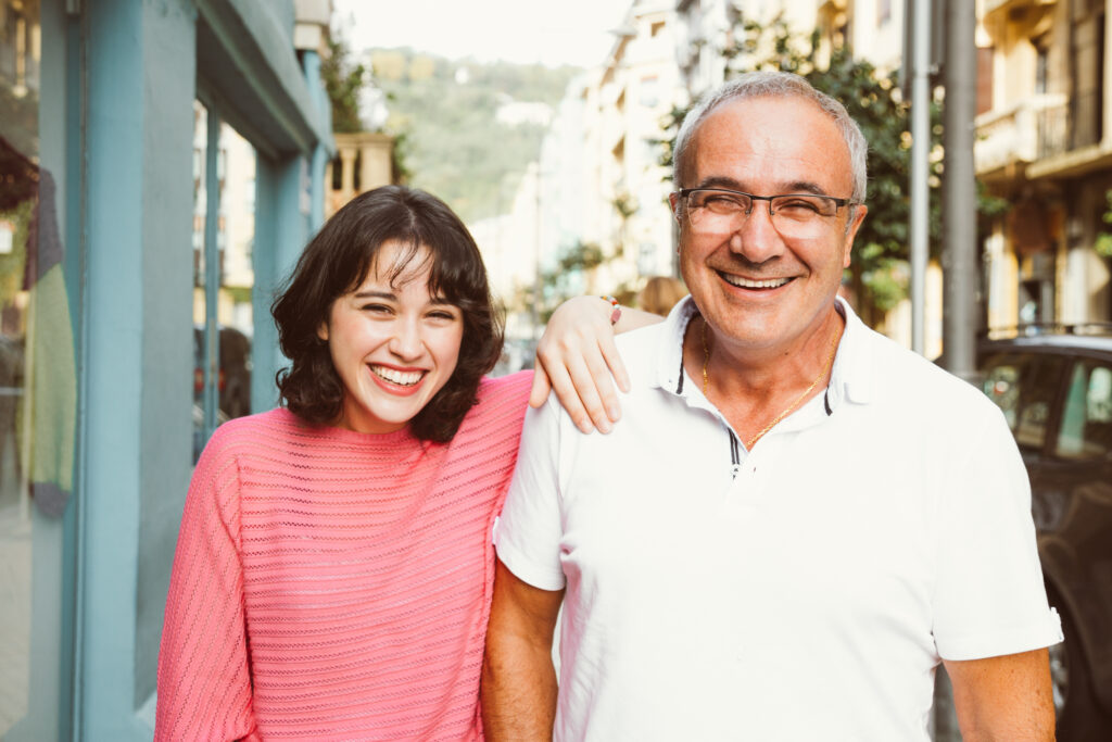 A father who purchased real estate for his child smiles at the camera.