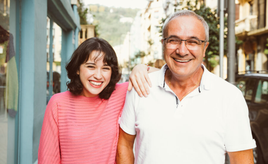 A father who purchased real estate for his child smiles at the camera.