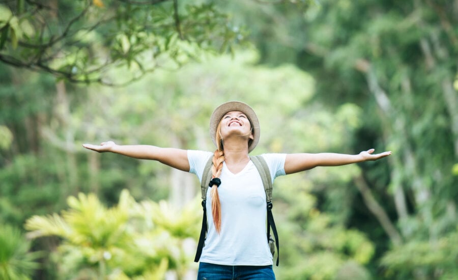 A woman looking extremely happy, inspiring the question, "Does money buy happiness?"