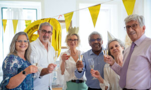 Six people celebrating retirement, symbolizing the five (plus one) factor for when to retire in Canada