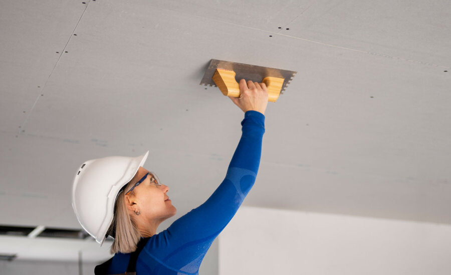 A woman repairs a ceiling, and this column talks about the U.S. debt ceiling, bank and retail earnings, optimism in investing and more.