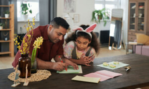 Father and daughter doing homework together, and he's wondering how much debt is normal for his age