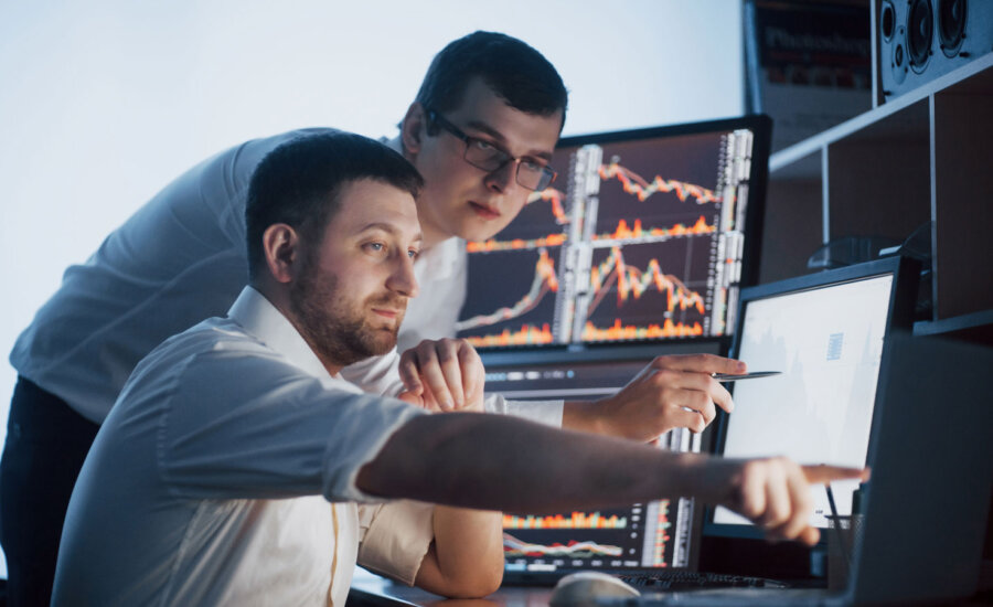 Two men looking at the stock market performance