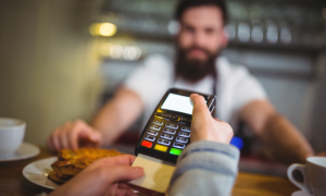 A customer leaves a tip at a restaurant in Canada using a POS machine.