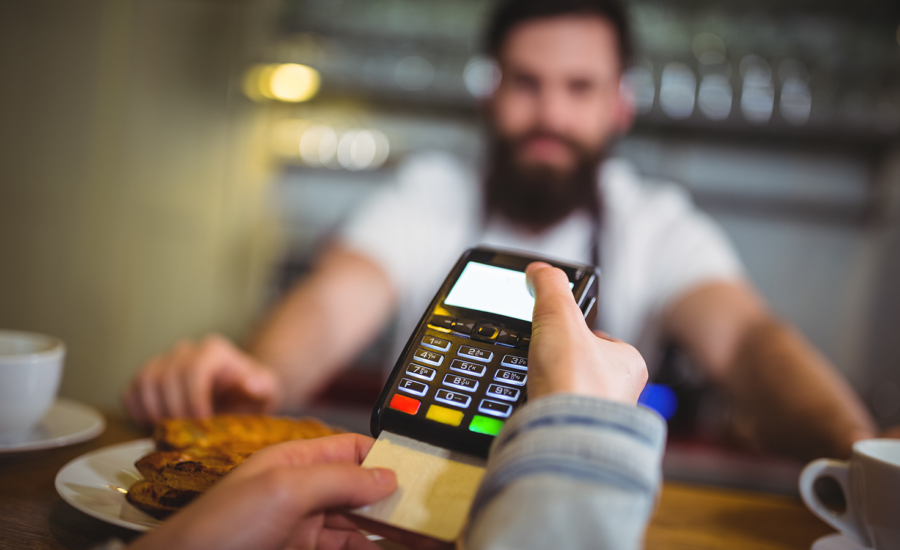 A customer leaves a tip at a restaurant in Canada using a POS machine.