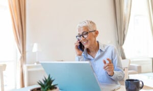 A woman in semi-retirement working from home, not looking stressed at all.