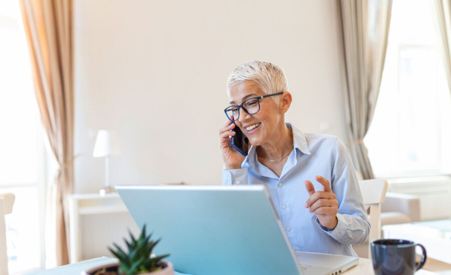 A woman in semi-retirement working from home, not looking stressed at all.