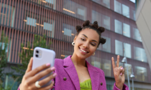 A stylish young influencer takes a selfie