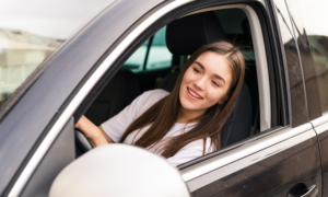 A young woman driving a car