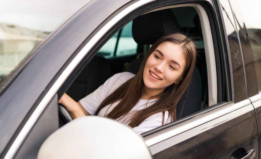 A young woman driving a car