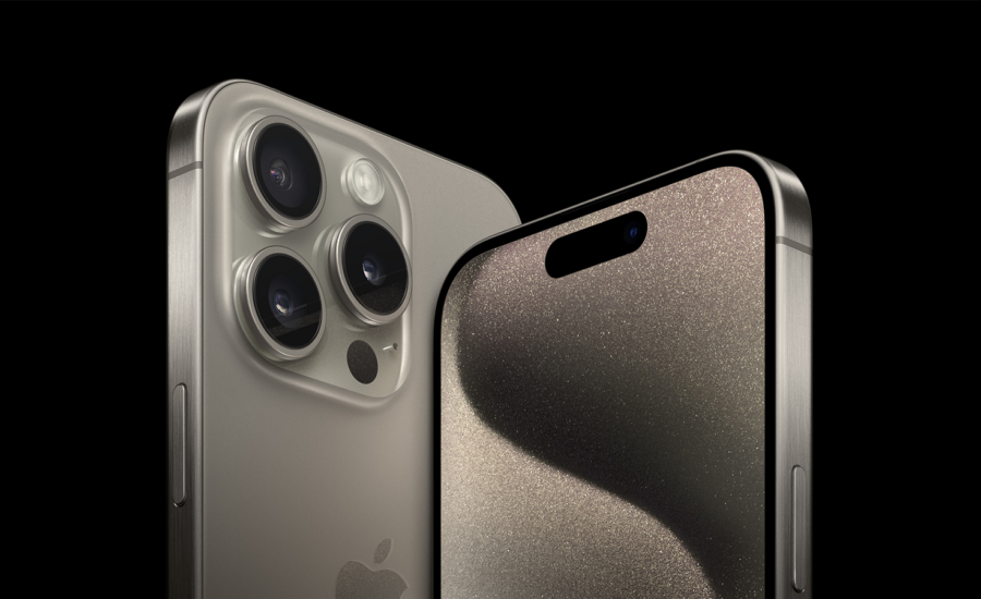 The new iPhone 15 Pro and Pro Max are pictured against a black background.