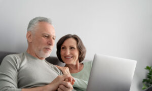 Couple looking at investing newsletters, deciding which ones to unsubscribe from.