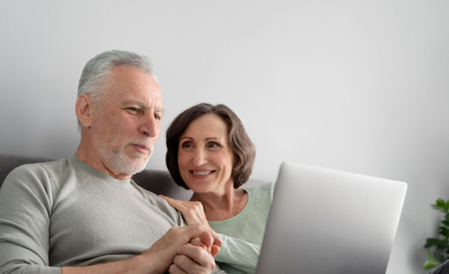 Couple looking at investing newsletters, deciding which ones to unsubscribe from.