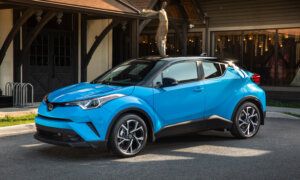 A blue Toyota CH-R small SUV on a home driveway