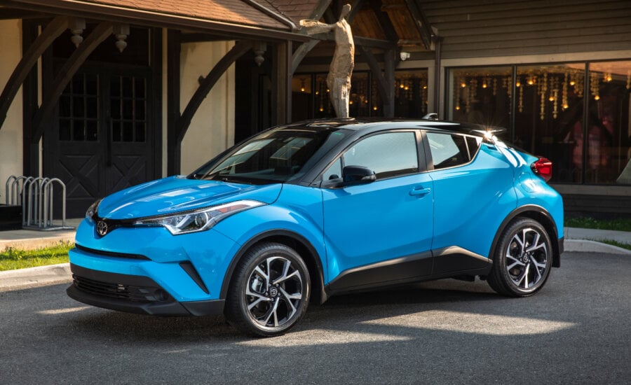 A blue Toyota CH-R small SUV on a home driveway