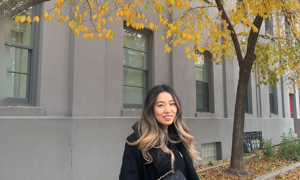 Canadian de-influencer Jennifer Wang is pictured in front of fall foliage.