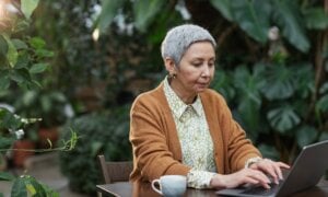 A woman reviews tax information online after receiving a severance payment