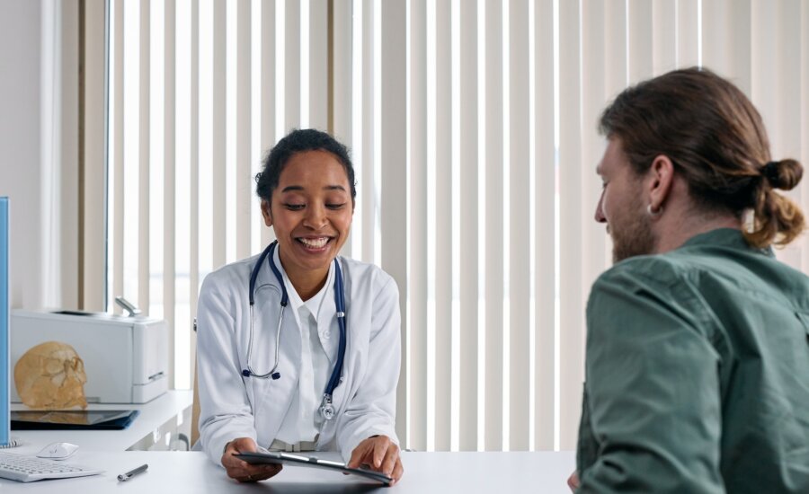 A young doctor meets with a patient who's in school