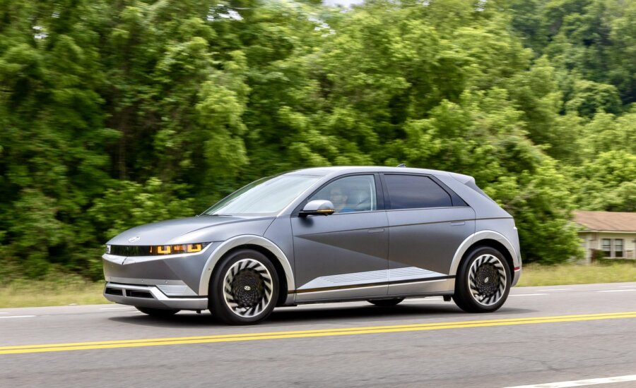 A grey Ioniq 5 drives down a street