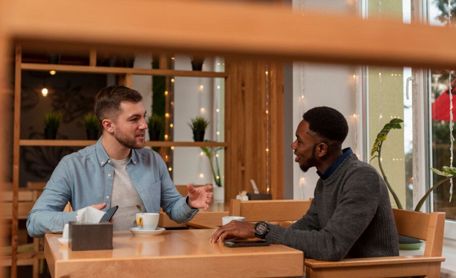 Two Canadian men talking about their money situations for an annual financial checkin.