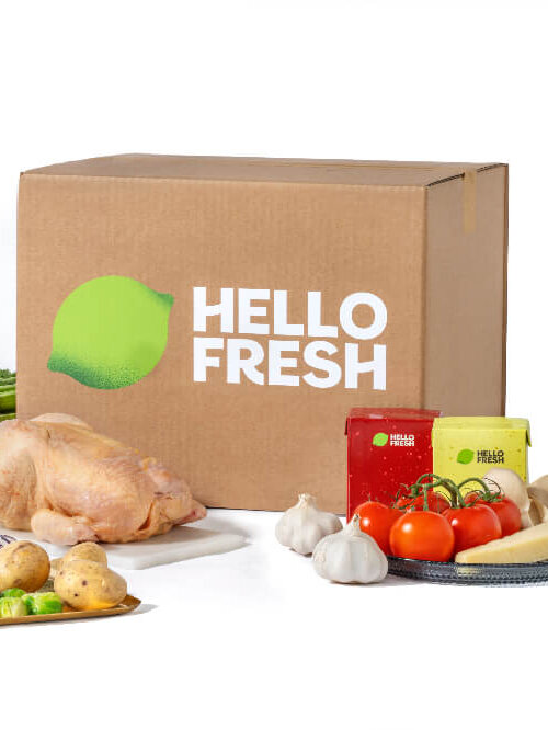 A Hello Fresh box surrounded by chicken and vegetables