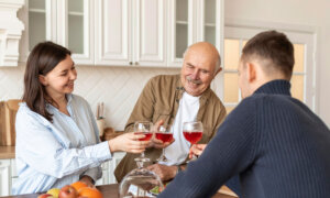 Father with adult children, toasting during good times. The father is happy as he's taken care of his estate and avoided probate fees in Ontario.