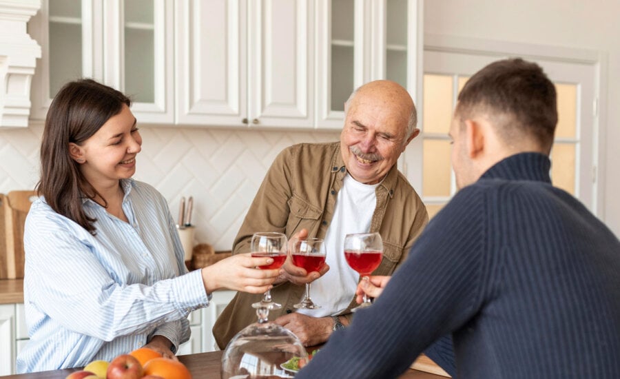 Father with adult children, toasting during good times. The father is happy as he's taken care of his estate and avoided probate fees in Ontario.