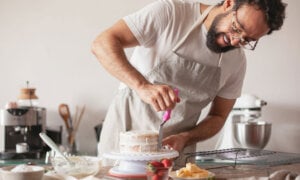 A man making a layered cake to symbolize filing multiple years in Canada