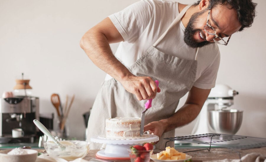 A man making a layered cake to symbolize filing multiple years in Canada