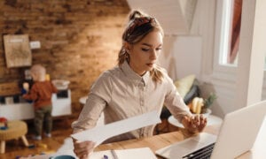 A woman doing her own taxes at home, filing her taxes online