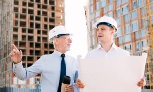 A father and his son watch as their future condo is built.