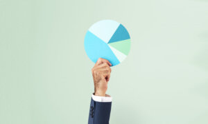 A man holding a pie chart: showing how assets are allocated in a portfolio as we cover the asset winners of 2023.