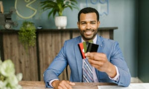 Canadian man holding up multiple credit cards.