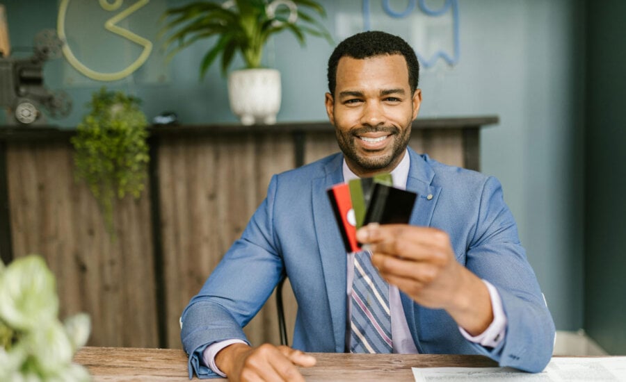 Canadian man holding up multiple credit cards.