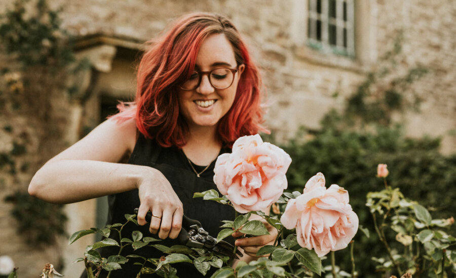 Woman pruning flowers to symbolize receiving dividends from Canadian ETFs