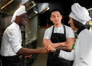 Three young cooks in a restaurant kitchen