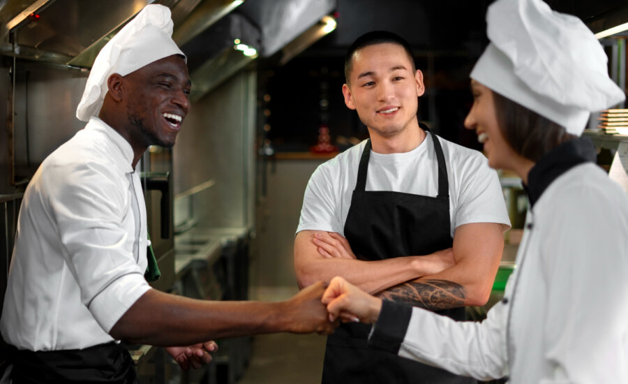 Three young cooks in a restaurant kitchen