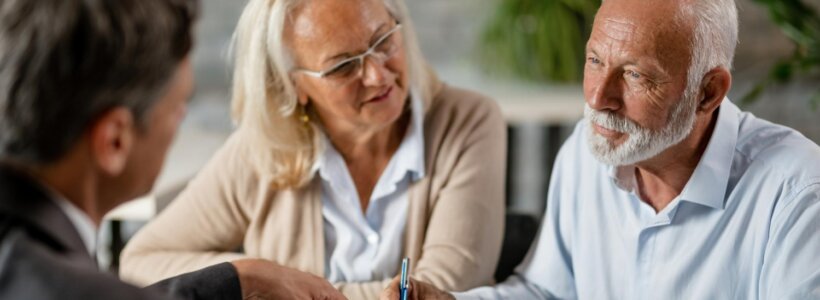 A retired couple speak with an accountant about the tax implications of their inherited property