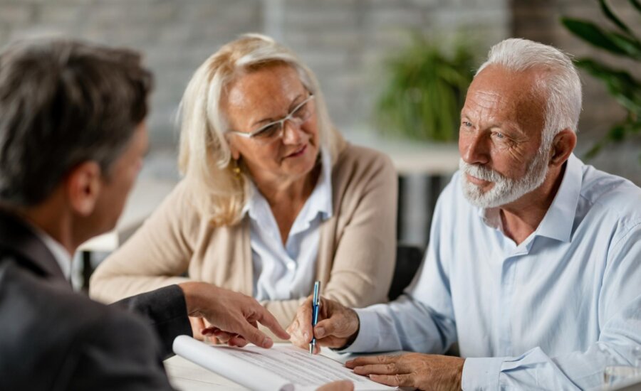 A retired couple speak with an accountant about the tax implications of their inherited property