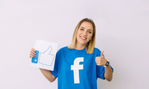 Woman in Facebook tee holding with thumb's up for liking the first dividend for Meta