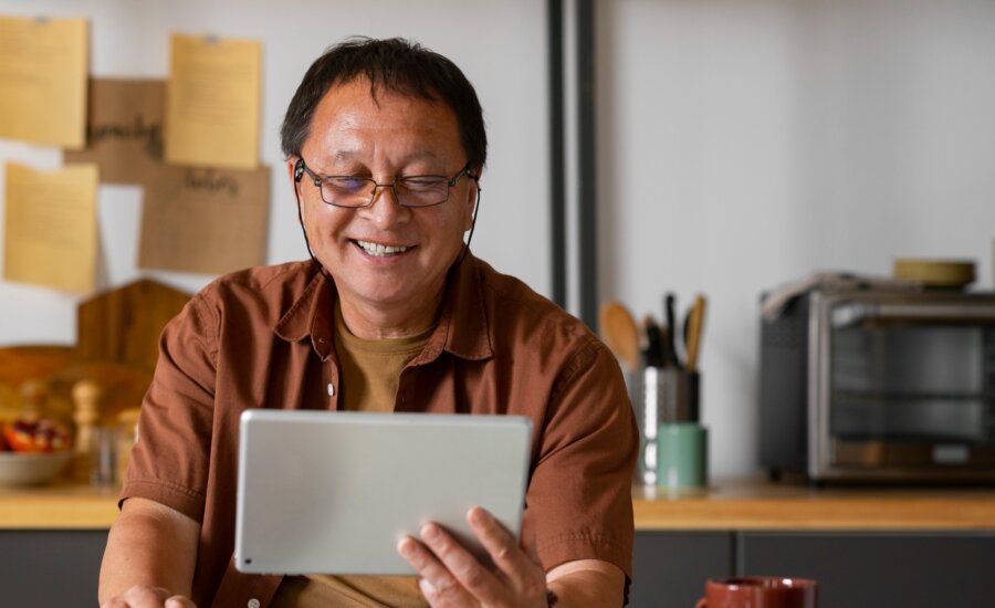 A man named Jing on his tablet at home