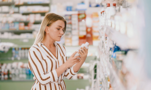 A woman shops for skin care in a drugstore.