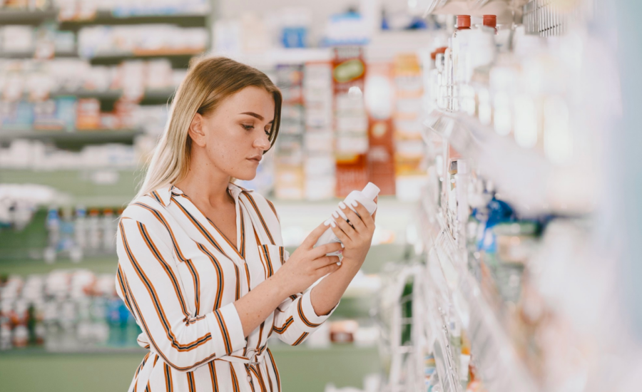 A woman shops for skin care in a drugstore.