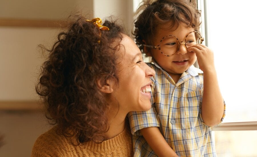 A woman and her smiling son, for whom she's opened a registered account