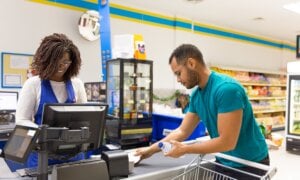 A man cashes out at the grocery store