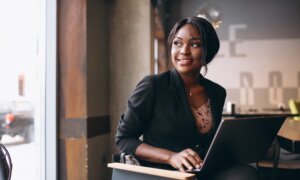 A woman works on her laptop in a cafe