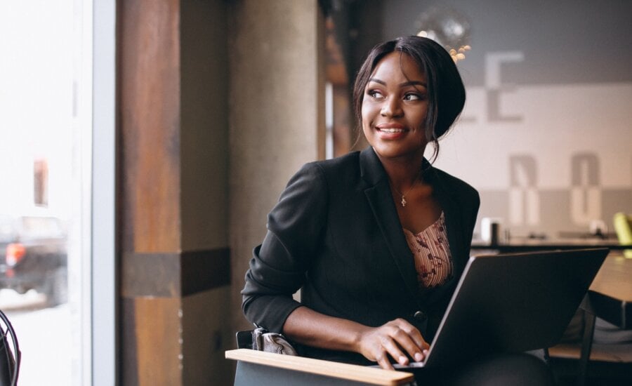 A woman works on her laptop in a cafe